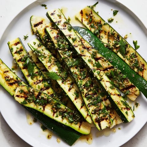Beautifully plated Garlic Herb Grilled Zucchini, seasoned with vibrant herbs, ready for a Mediterranean feast.