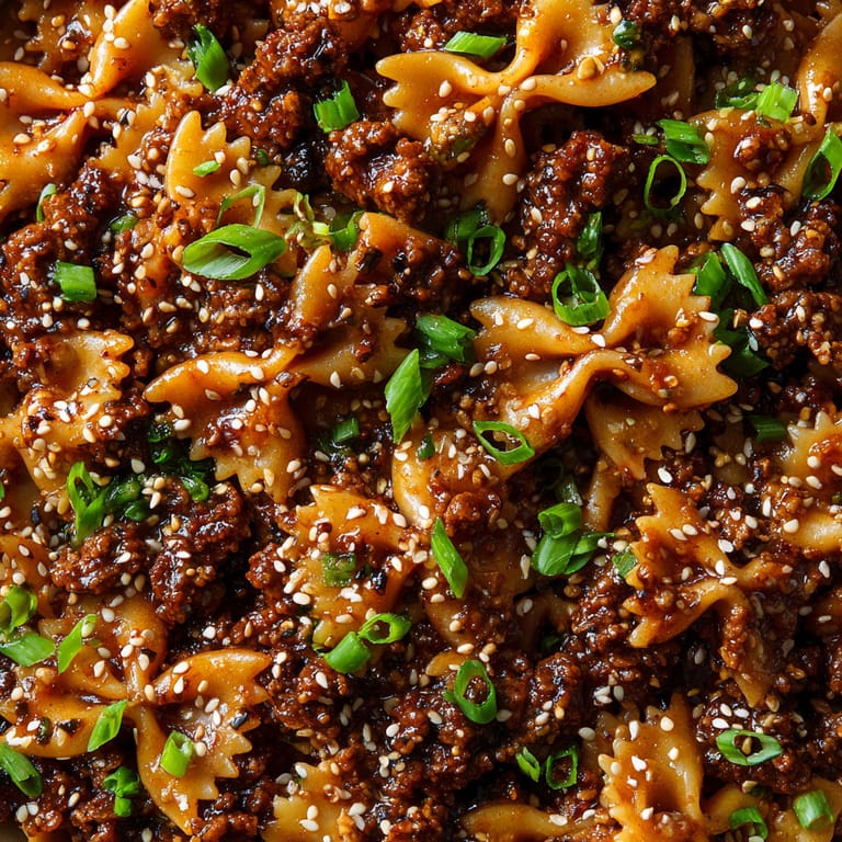 A close up of a dish with noodles and meat.