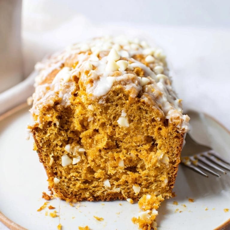 Homemade Pumpkin White Chocolate Muffin Loaf, aromatic spices fill the air—ready for sharing.