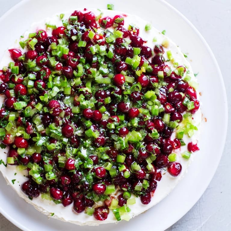 Festive Spiced Cranberry Jalapeño Cream Cheese Dip piled high on a serving dish, ready to be enjoyed.