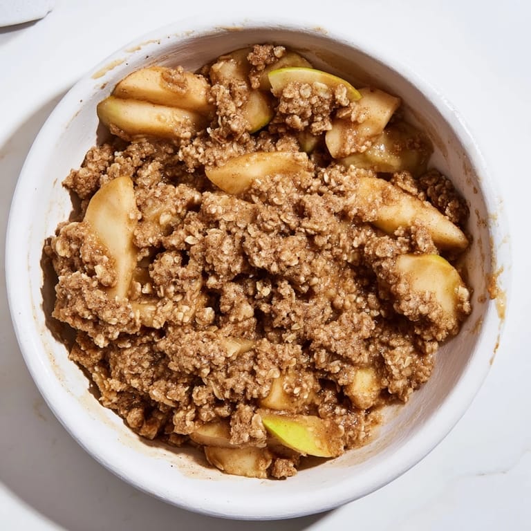 Warm and comforting Apple Crisp with a crispy oat topping, baked to perfection in a square dish.