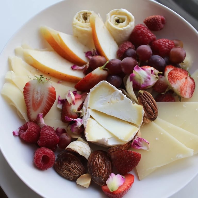 A vibrant Rose Garden Romantic Platter featuring a colorful array of fruits and gourmet cheese selections for sharing.