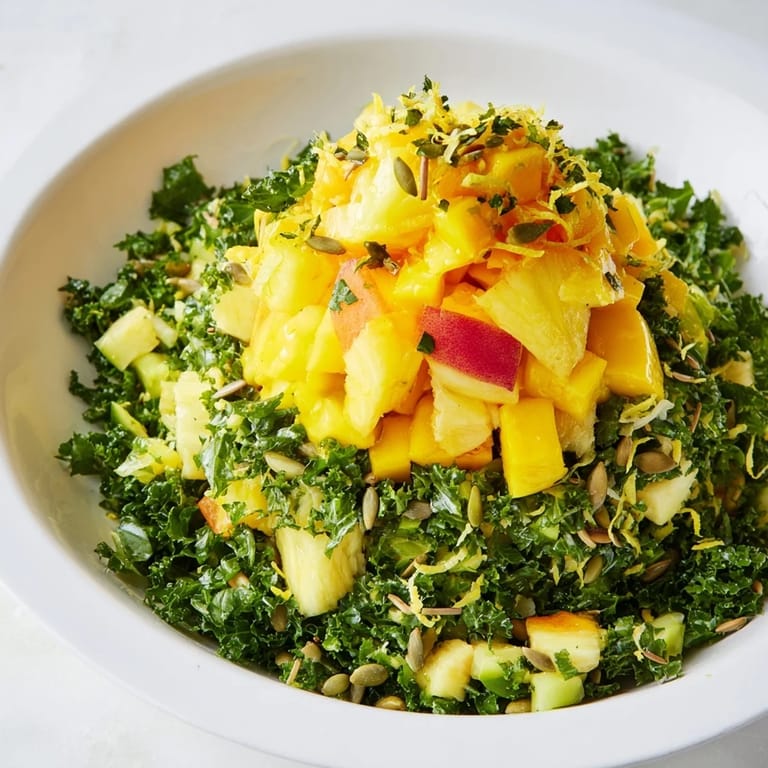A beautiful bowl of The Sunlit Glade salad: a colorful mix of seasonal fruits and fragrant herbs.