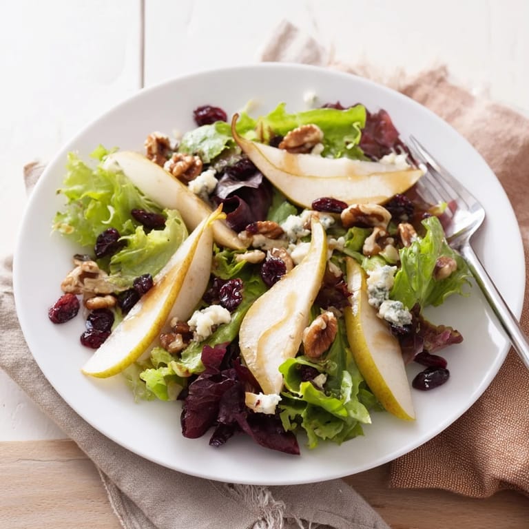 Pear Gorgonzola Salad served as a light meal, featuring colorful greens, tangy cheese, sweet pear slices, and crunchy toasted walnuts.