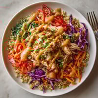 A bowl of food with a fork next to it.