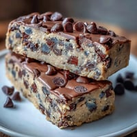 Delicious edible cookie dough protein bars with mini chocolate chips, perfect for a healthy post-workout snack.  