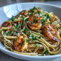 Vibrant spring dinner party lemon garlic shrimp pasta with fresh parsley and grated Parmesan.