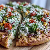 St. Patricks Day Rainbow Veggie Flatbread Pizza with vibrant vegetables arranged in a festive rainbow pattern on a crispy crust.