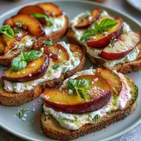 Creamy burrata and juicy honey-glazed peaches top rustic sourdough in this vibrant spring brunch toast.