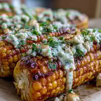 Elote-Style Microwave Corn on the Cob with Cotija, creamy and cheesy, topped with chili and lime.  